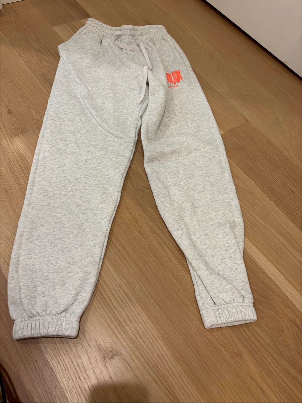 White Fox Boutique Cloudburst Sweatpants with Neon Orange Logo